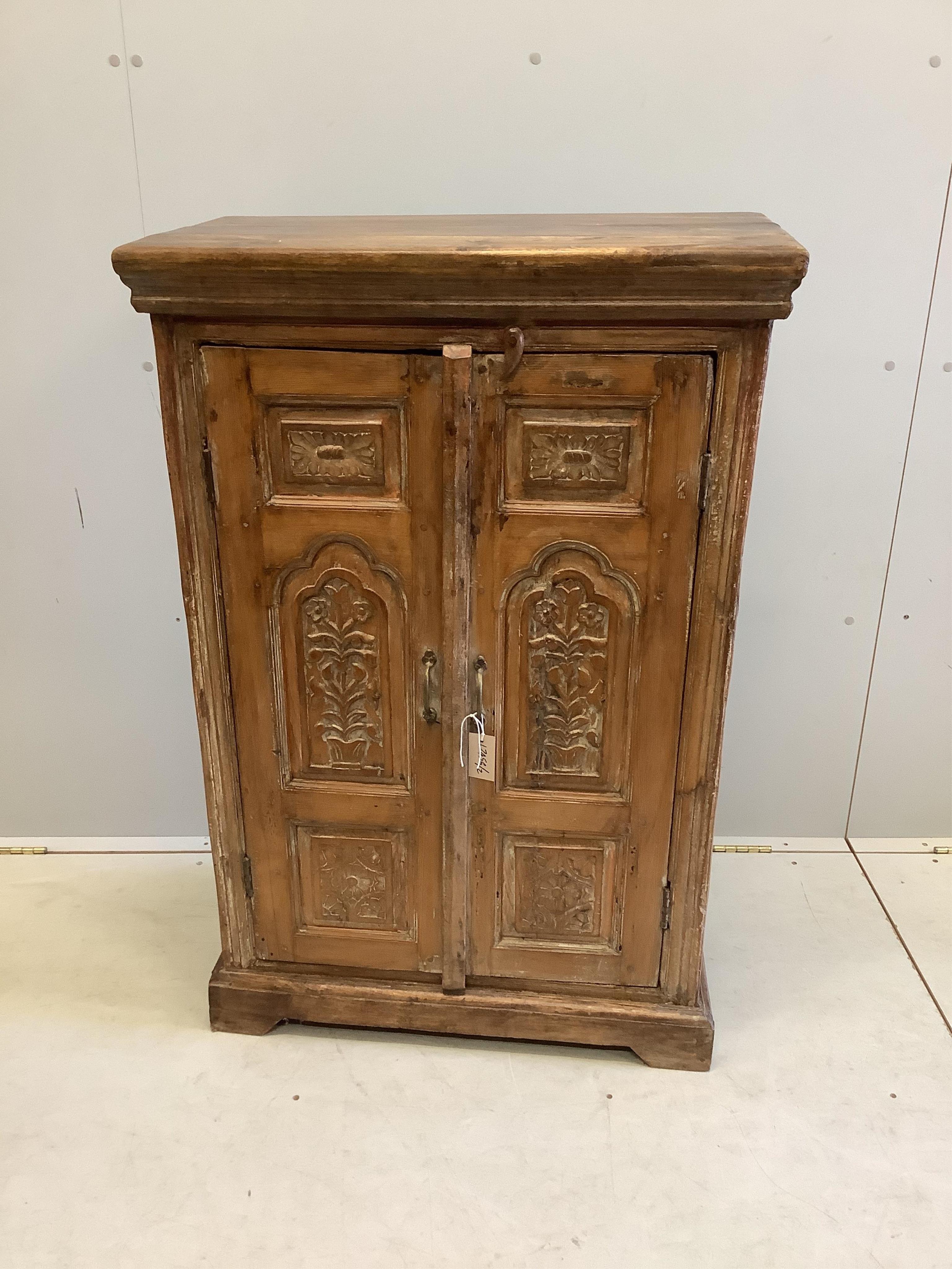 An Indonesian carved hardwood two door side cabinet, width 74cm, depth 39cm, height 112cm